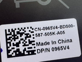 Close-up of a battery with a label containing a QR code and text on a metallic surface.